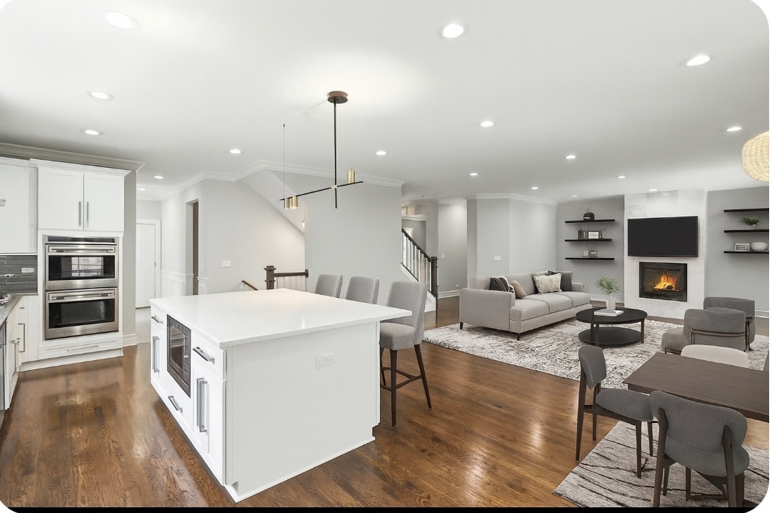 1127 Kenton Road Deerfield, IL 60015 - Photo 10 of 32 a large kitchen with stainless steel appliances kitchen island granite countertop a large kitchen island a stove a sink a dining table and chairs