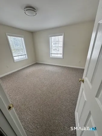a view of an empty room and a window