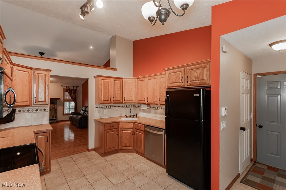 4815 South Ridge Road Perry, OH 44081 - Photo 4 of 48 Kitchen featuring black appliances, decorative backsplash, light tile patterned floors, and light brown cabinetry