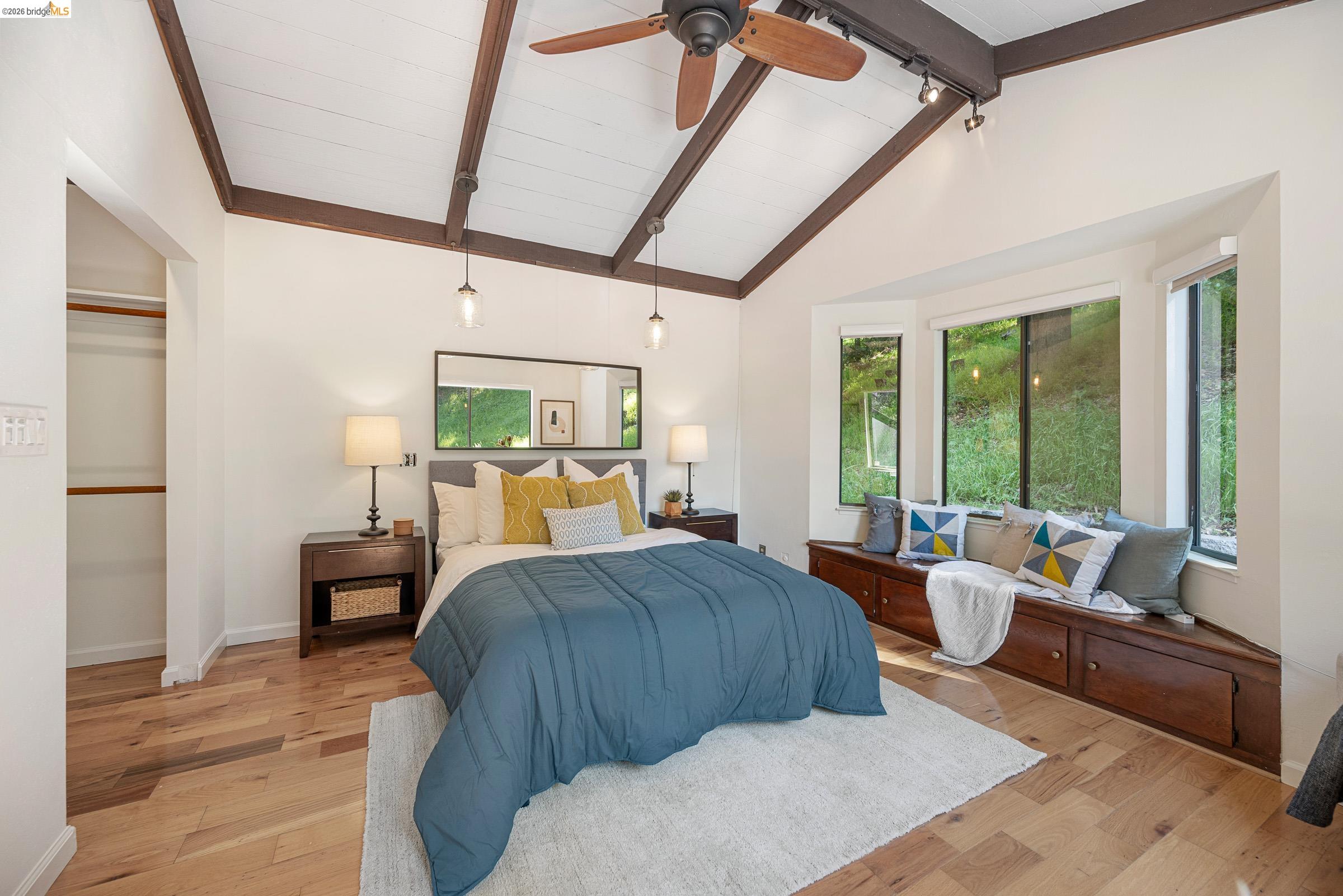 6600 Heather Ridge Way Oakland, CA 94611 - Photo 44 of 66 Vaulted ceiling with exposed wood beams, a ceiling fan, and track lighting