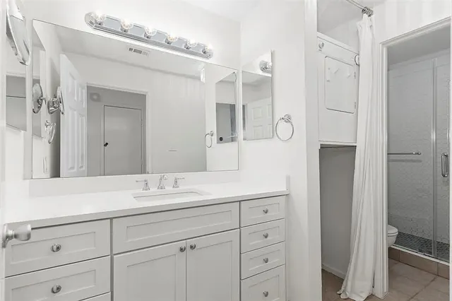 a bathroom with a shower sink and mirror