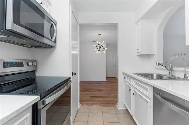 a kitchen with a sink stove and cabinets