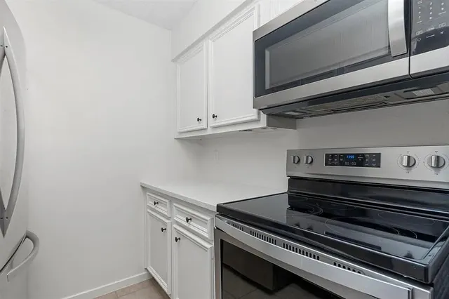 a stove top oven sitting inside of a kitchen