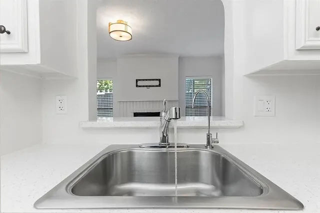 a close view of a sink a faucet and appliance in the kitchen