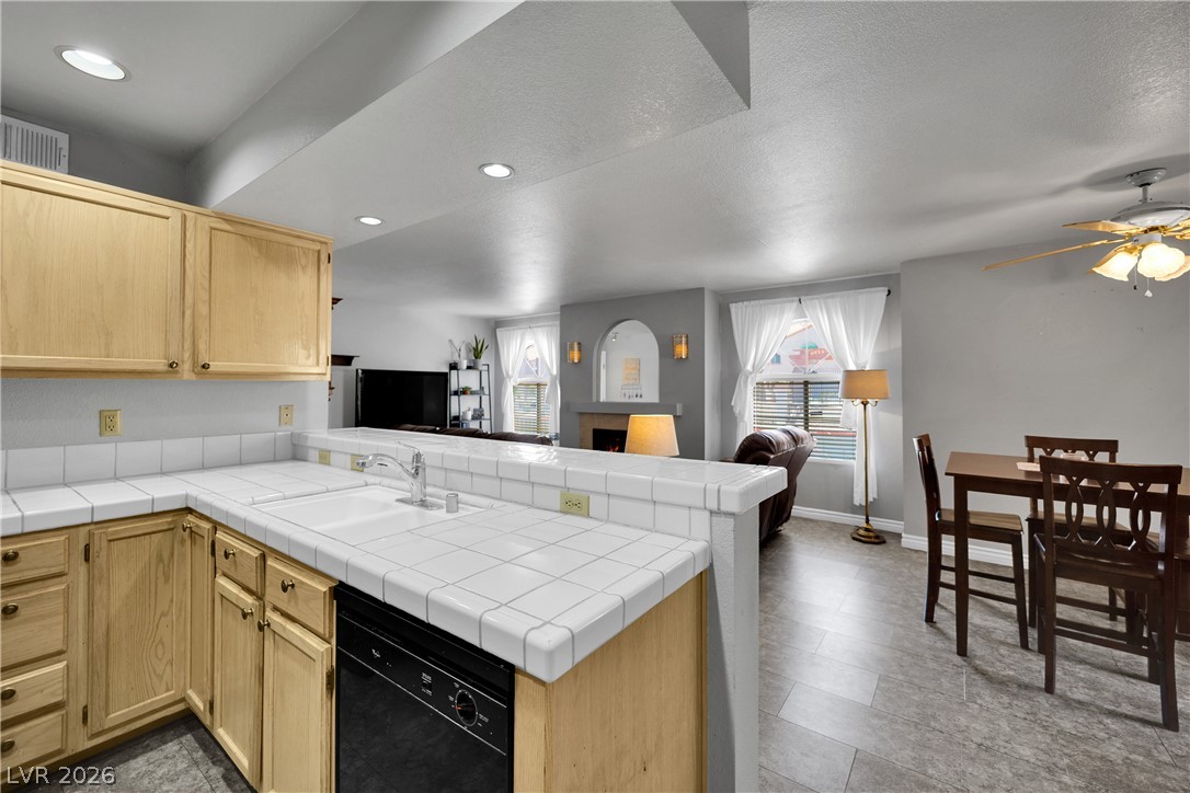 7570 West Flamingo Road, Unit 115 Las Vegas, NV 89147 - Photo 34 of 34 An open floorplan seamlessly connects the kitchen and dining area, ideal for entertaining.