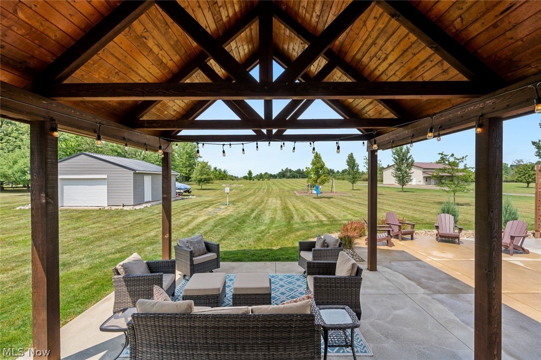 6517 Stone Road Medina, OH 44256 - Photo 35 of 47 View of patio / terrace featuring a garage, an outbuilding, and an outdoor hangout area