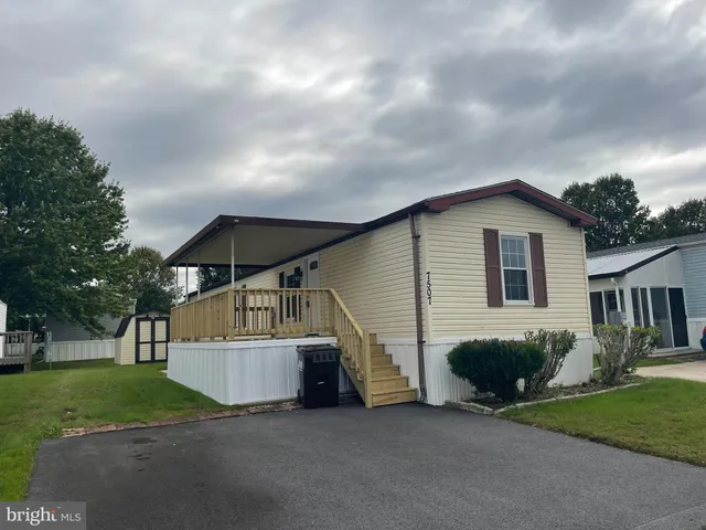a view of house with outdoor space and sitting area