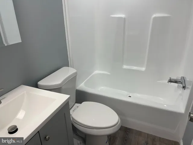 a white toilet sitting next to a bathroom sink