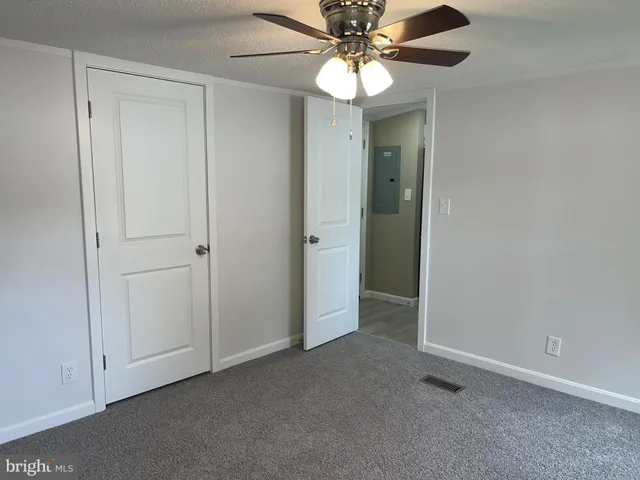 an empty room with a ceiling fan