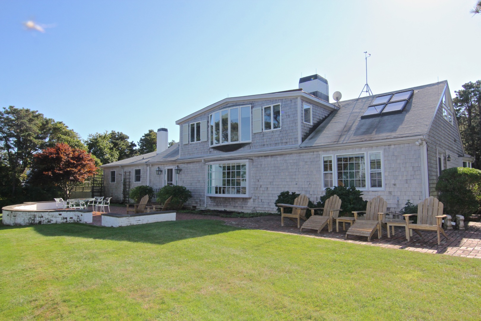 7 Green Hollow Road Edgartown, MA 02539 - Photo 7 of 53 a view of a house with outdoor seating area and furniture