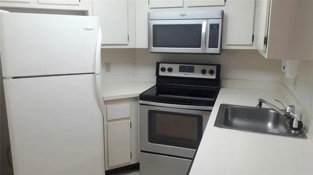 a stove top oven sitting inside of a kitchen