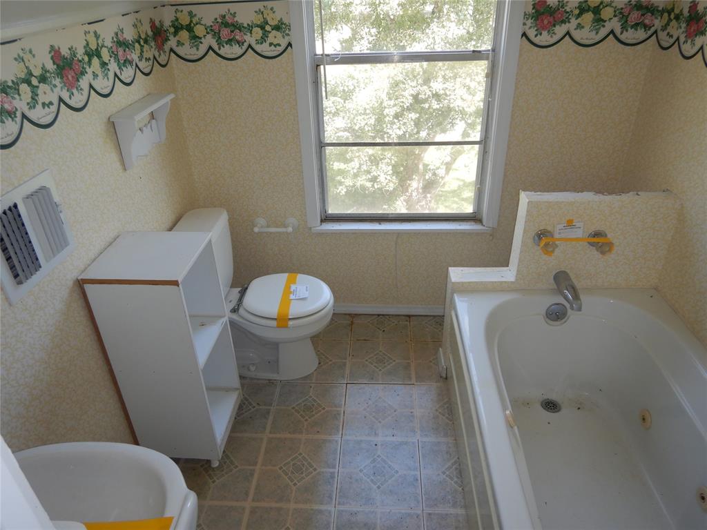 533 Holly Street Grand Cane, LA 71032 - Photo 12 of 15 a bathroom with a sink and a toilet