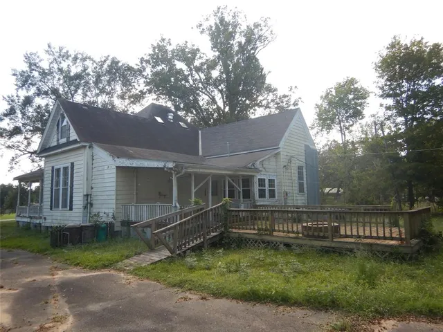 a view of house with backyard and a garden