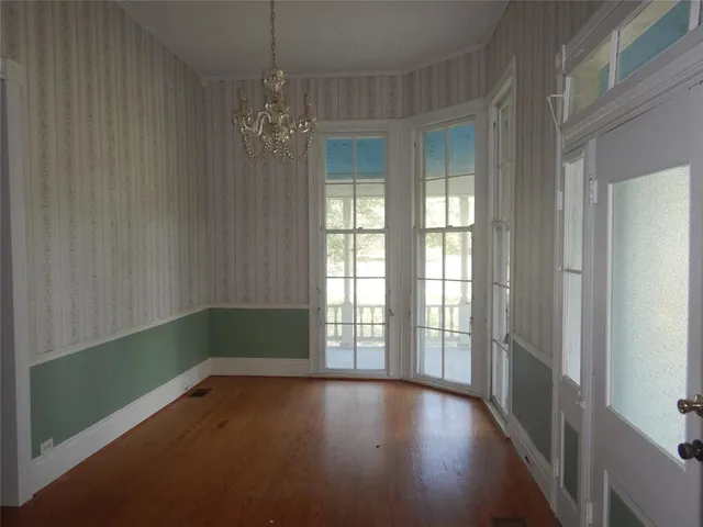 a view of a room with window and wooden floor