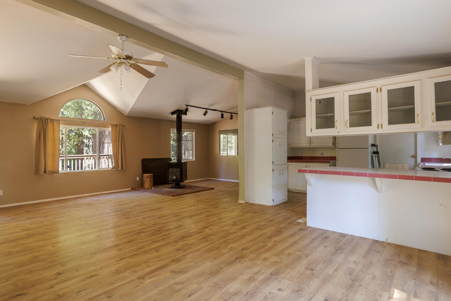 7140 Darling Cabin Road Garden Valley, CA 95633 - Photo 17 of 34 a view of empty room with wooden floor and fan