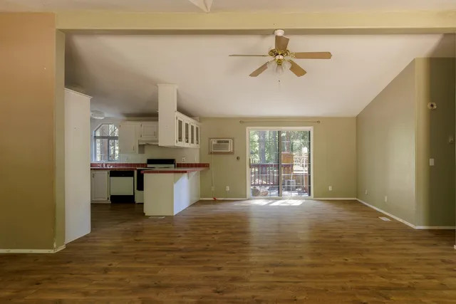 a view of kitchen with wooden floor and a window