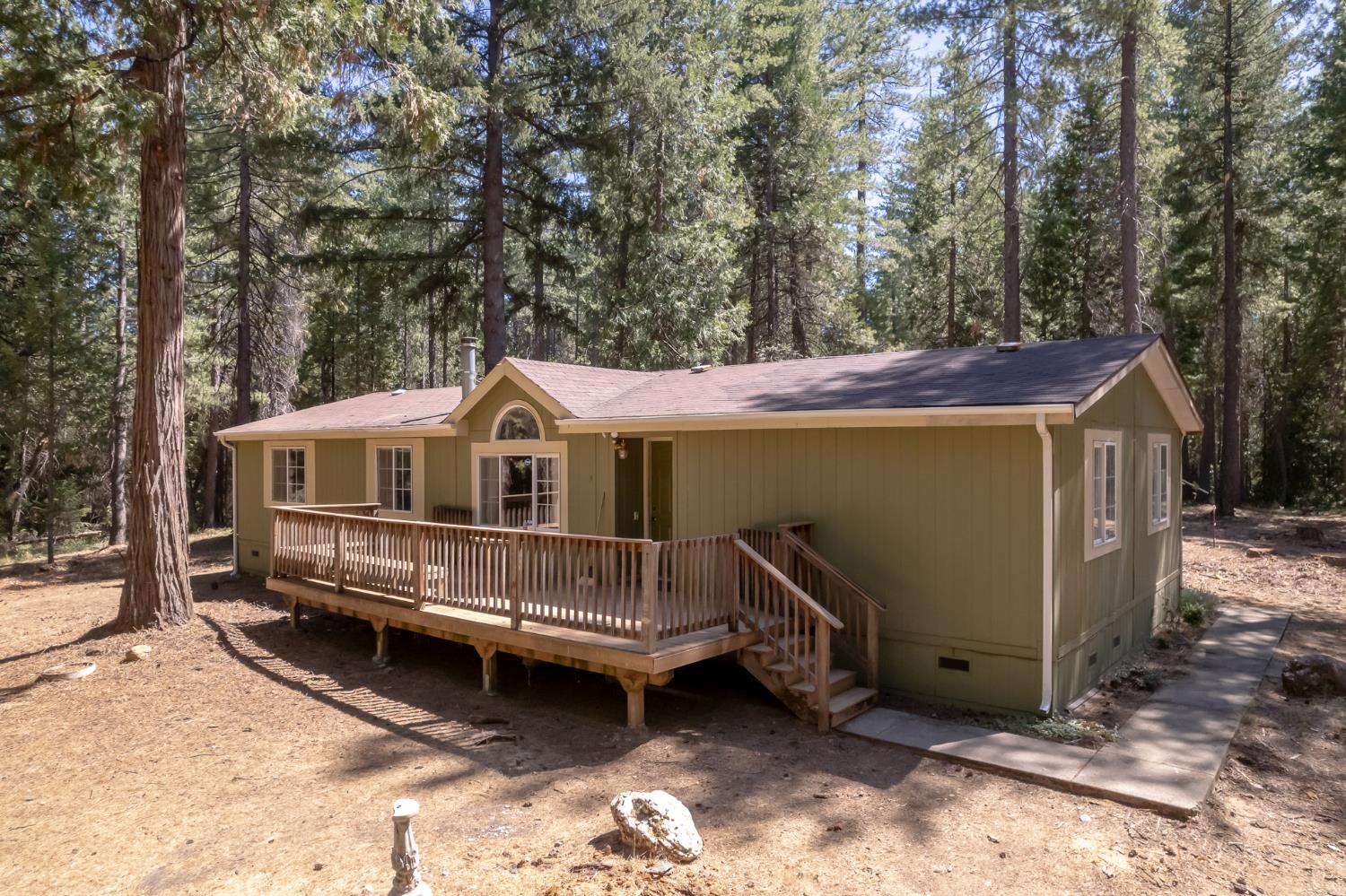 7140 Darling Cabin Road Garden Valley, CA 95633 - Photo 31 of 34 a view of a wooden house with a yard and large trees
