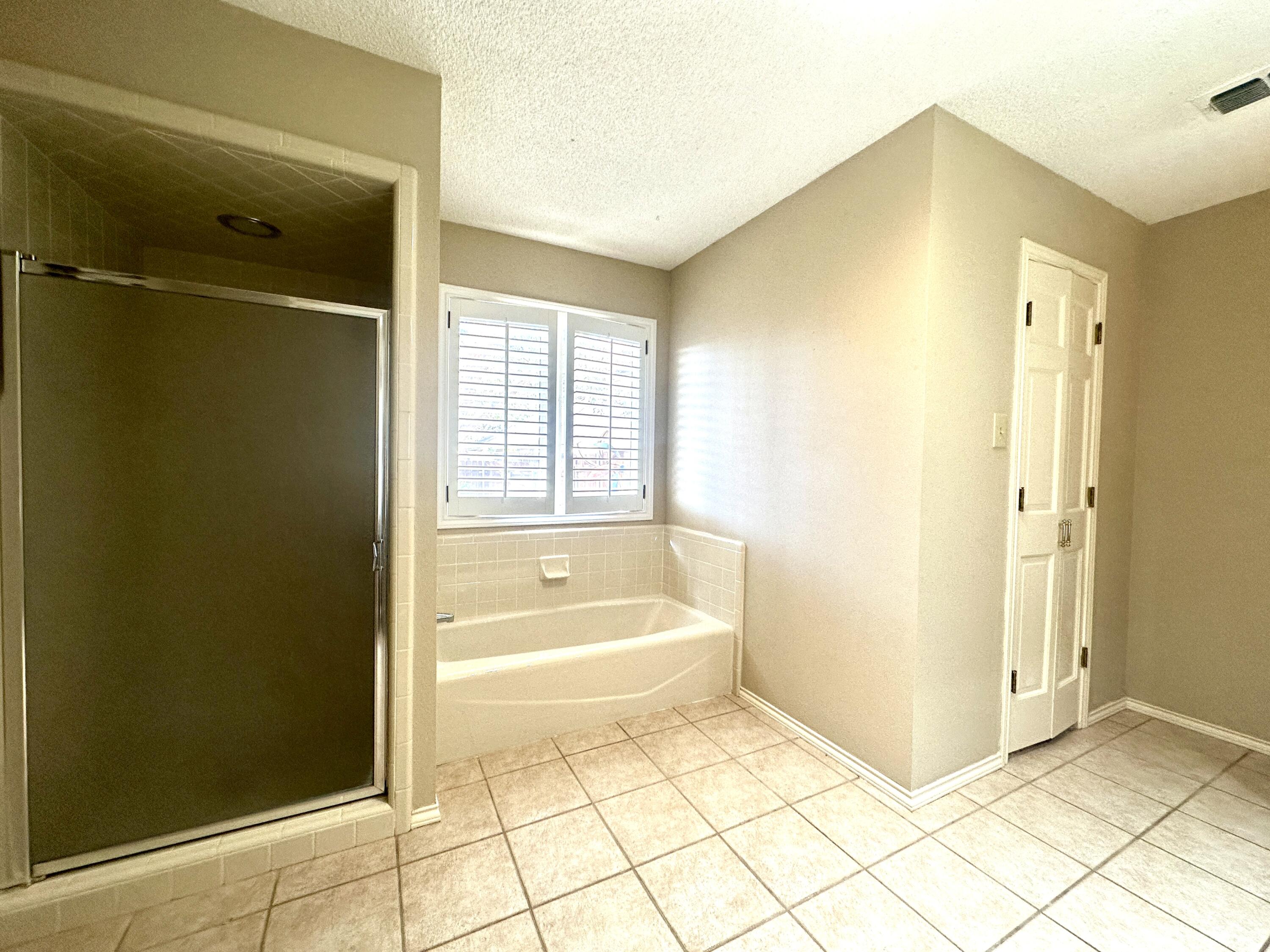 8614 Memphis Avenue, Unit B Lubbock, TX 79423 - Photo 11 of 11 a bathroom with a bathtub and a shower