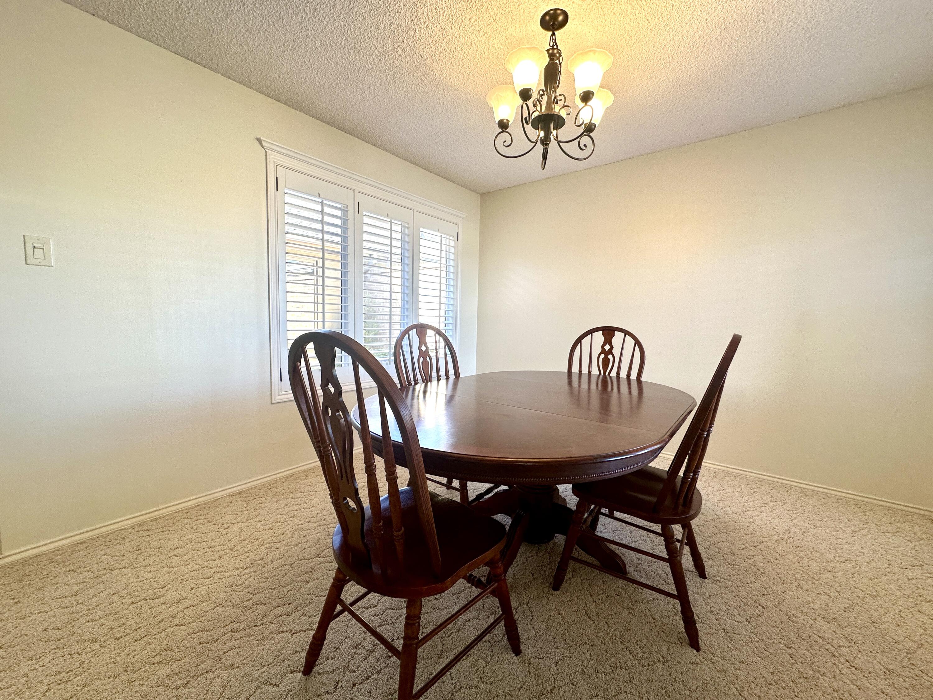 8614 Memphis Avenue, Unit B Lubbock, TX 79423 - Photo 3 of 11 a view of a dining room with furniture window and outside view