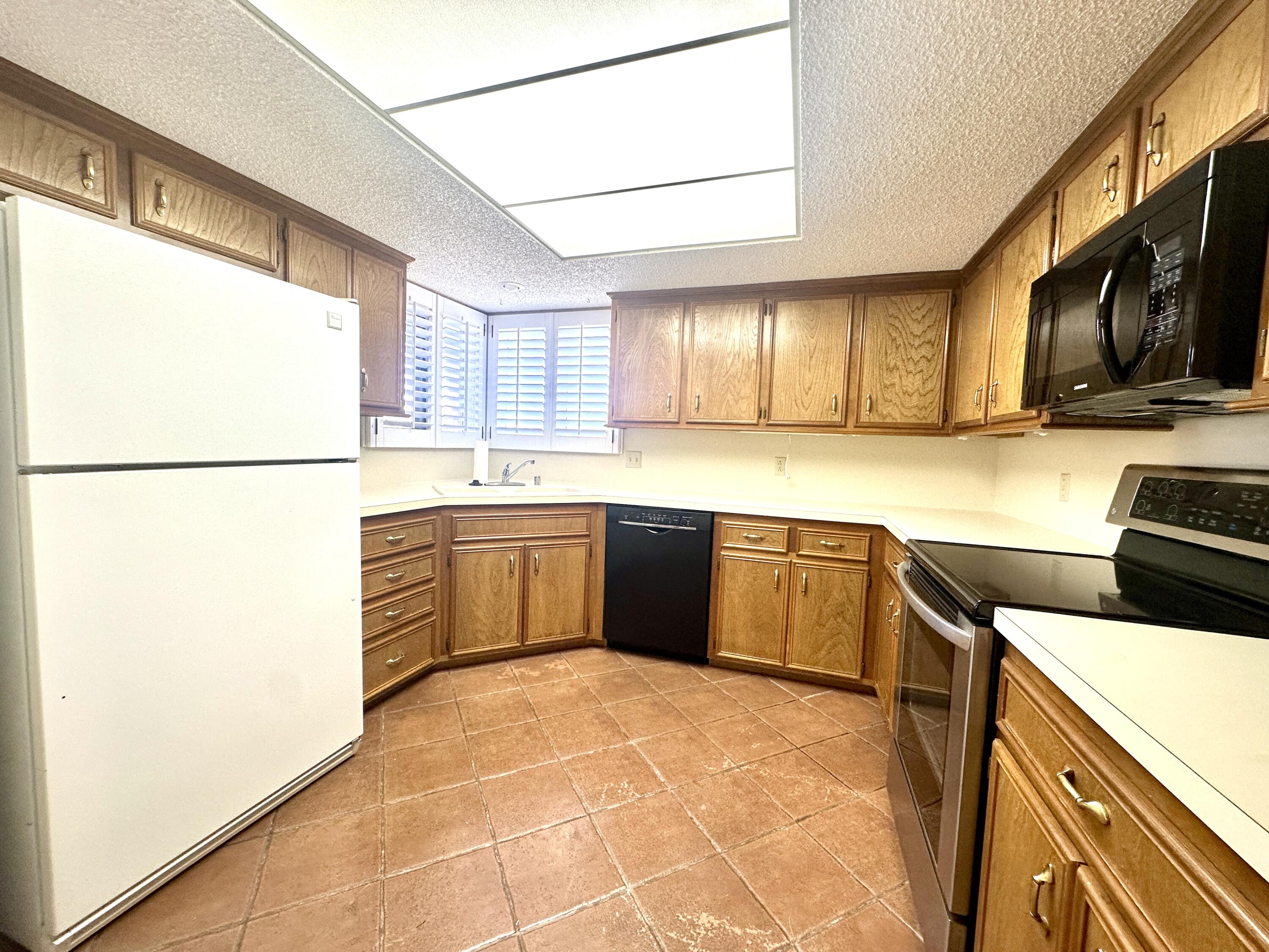 8614 Memphis Avenue, Unit B Lubbock, TX 79423 - Photo 5 of 11 a kitchen with stainless steel appliances a stove a sink and a refrigerator