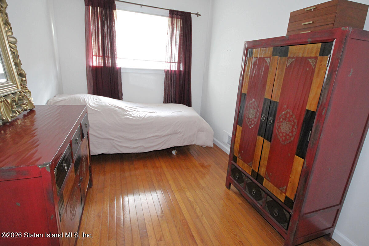 951 West Fingerboard Road Staten Island, NY 10304 - Photo 18 of 29 a bedroom with a bed and a mirror