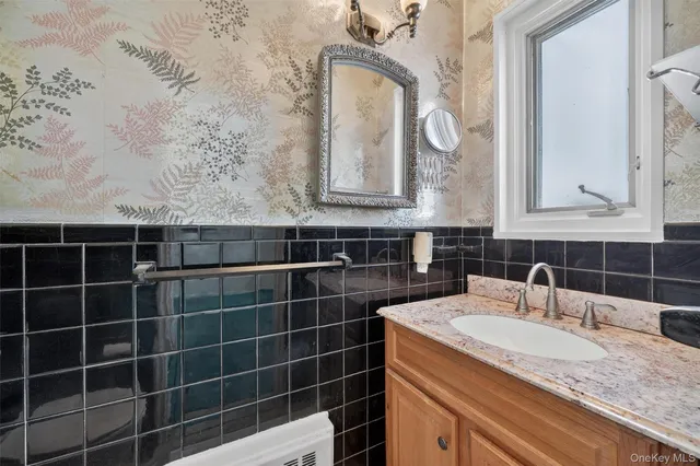 a bathroom with a sink mirror and toilet