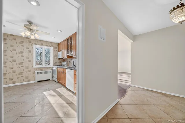 a view of a kitchen with a sink and dishwasher with a fireplace