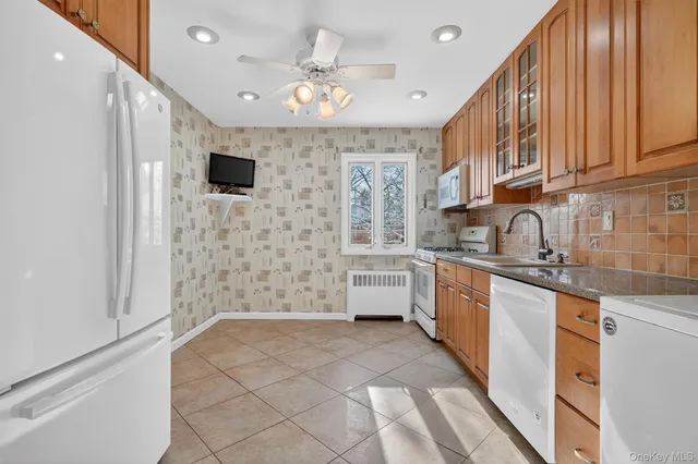 a kitchen with stainless steel appliances a refrigerator sink and microwave