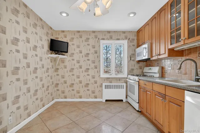 a kitchen with stainless steel appliances a stove sink and microwave