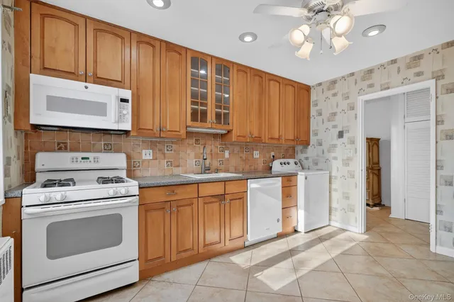 a kitchen with cabinets appliances and a sink