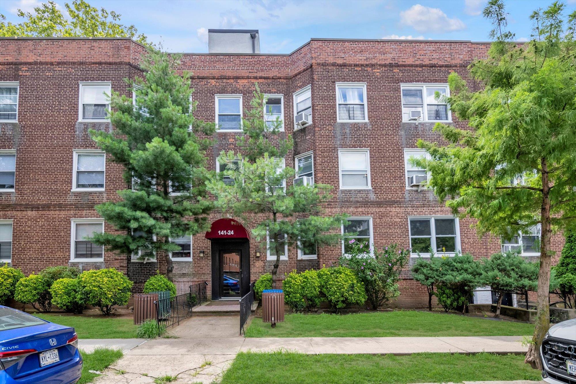 a front view of a house with yard and green space