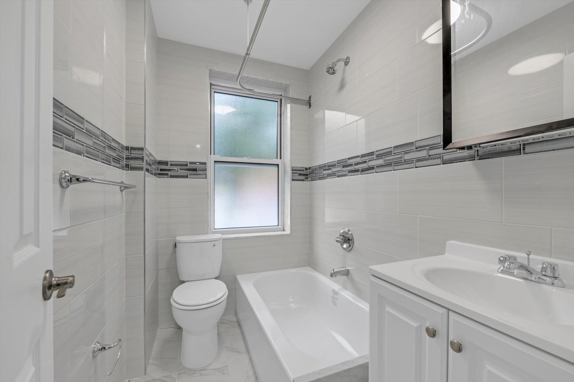 141-24 78th Avenue, Unit 1A Queens, NY 11367 - Photo 12 of 12 a bathroom with a sink toilet and shower