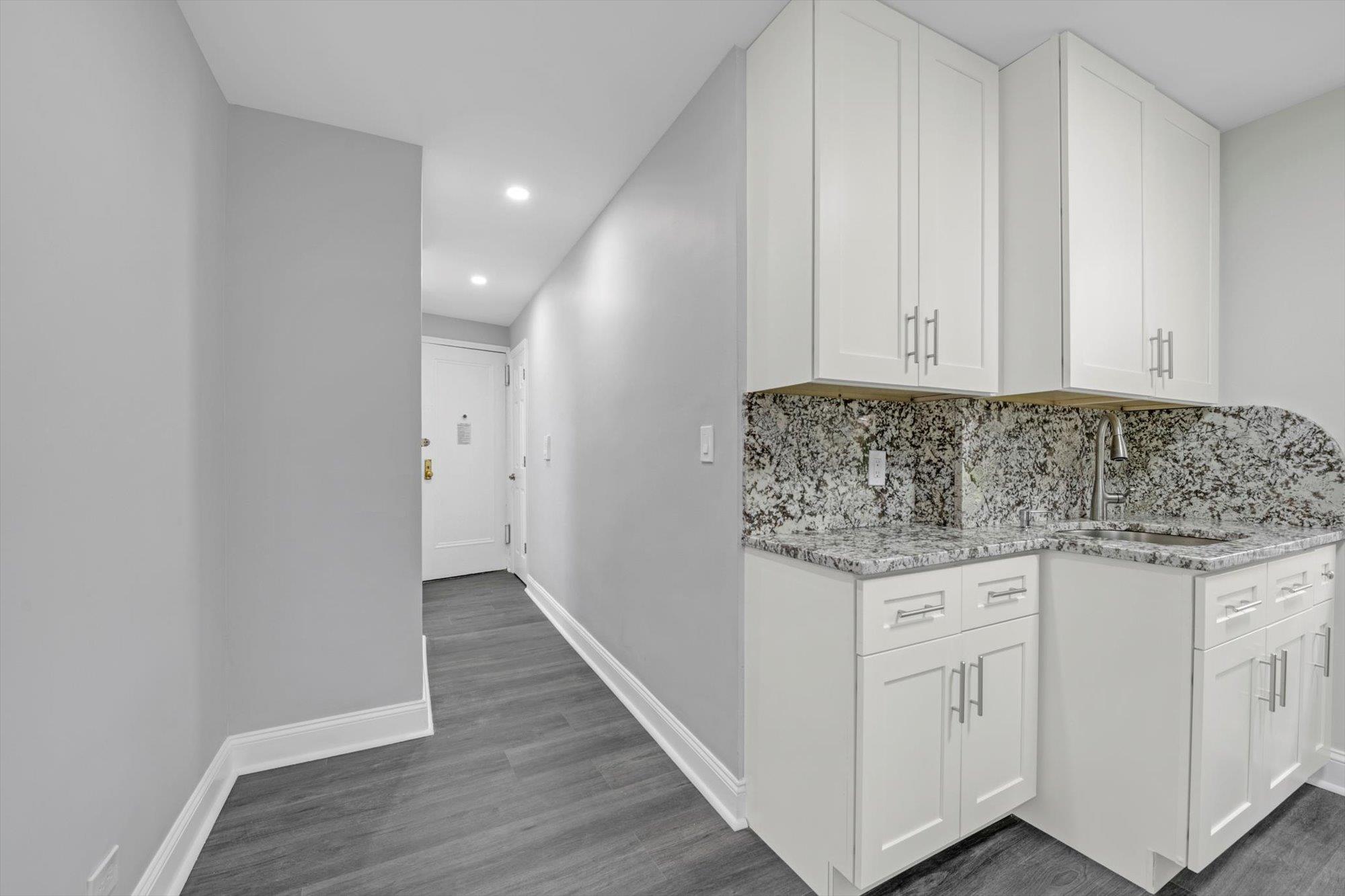 141-24 78th Avenue, Unit 1A Queens, NY 11367 - Photo 9 of 12 a utility room with granite countertop cabinets and washer dryer