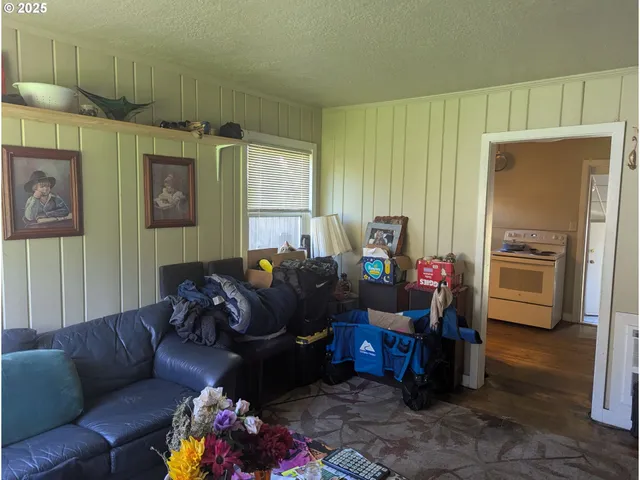a living room with furniture fireplace and a window