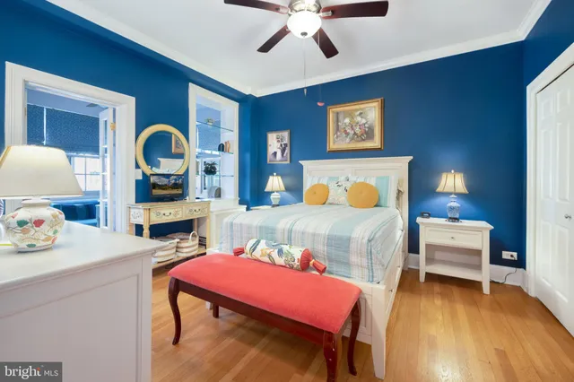 a bedroom with a bed and a dresser with mirror