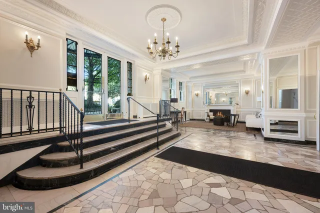 a view of a hallway with wooden floor and a bathroom