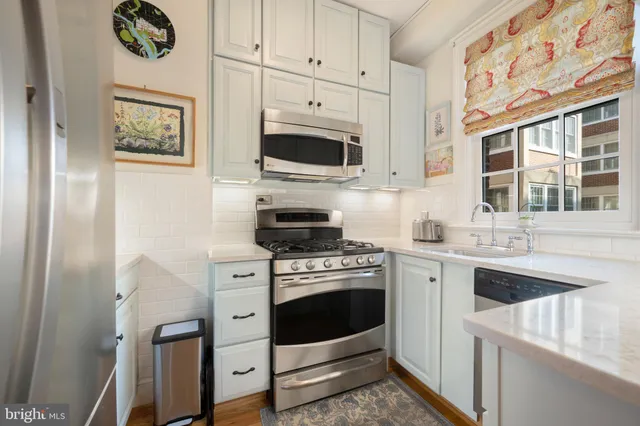 a kitchen with stainless steel appliances a sink and a stove