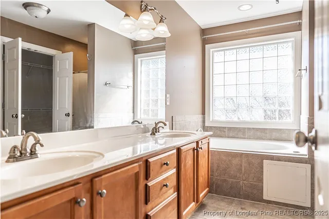 a bathroom with a bathtub and a window