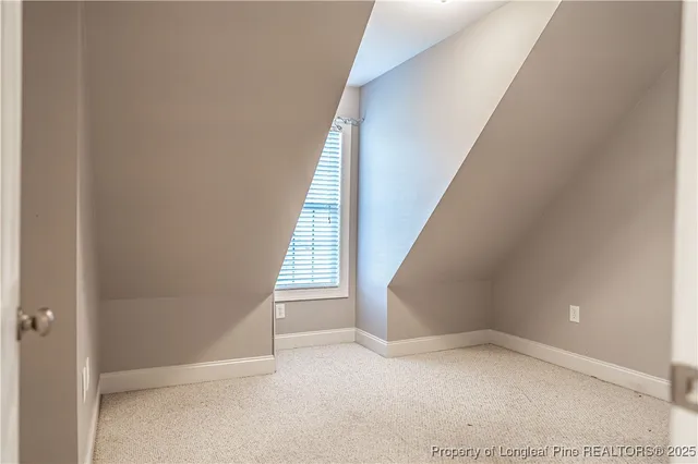 a view of an empty room with a ceiling fan