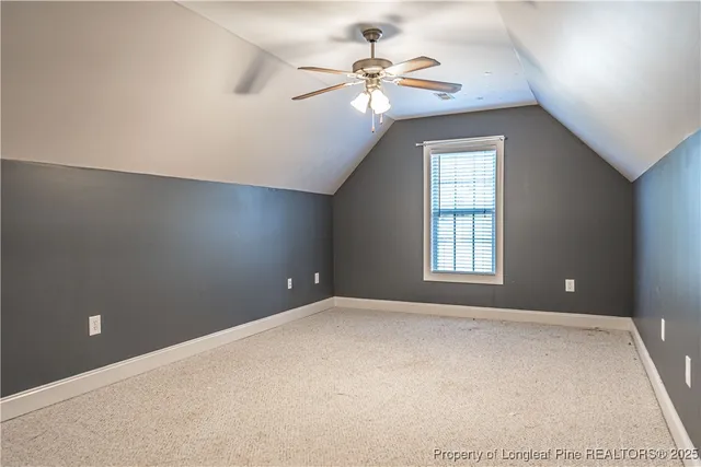 a view of staircase with railing and a chandelier