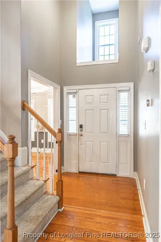 a view of an entryway with wooden floor and a rug