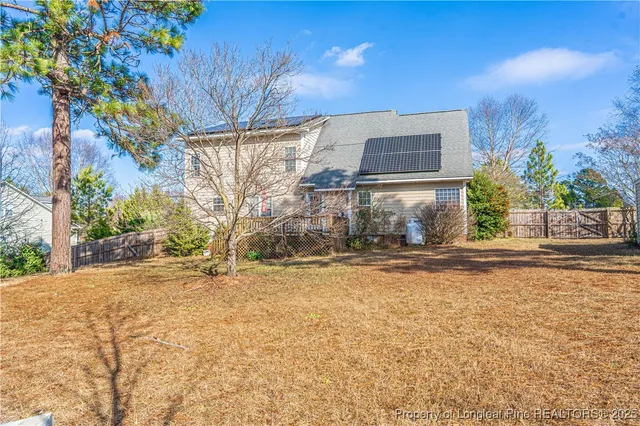 an aerial view of a house with garden space and street view