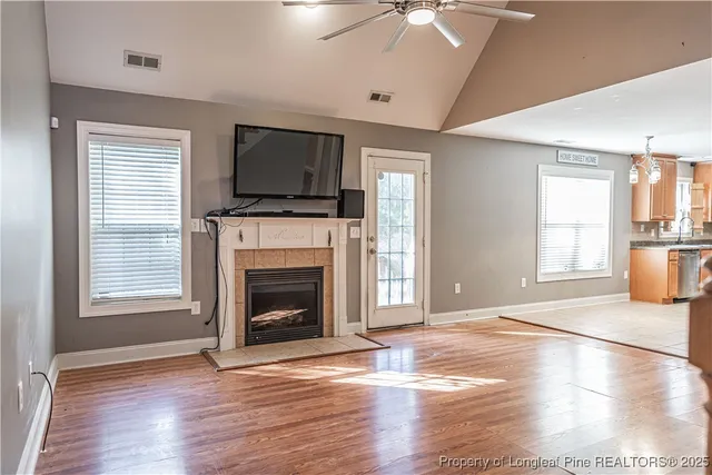 a view of an empty room with a fireplace and a window