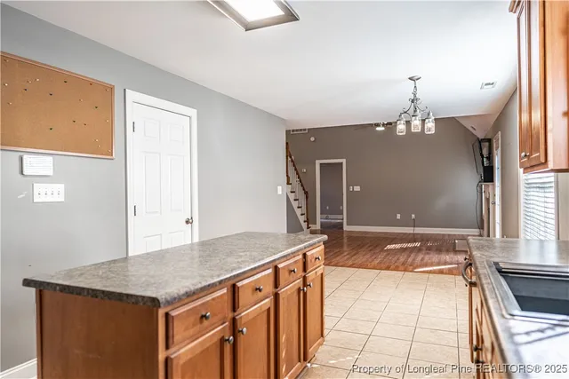 a kitchen with stainless steel appliances granite countertop a stove a refrigerator and a microwave