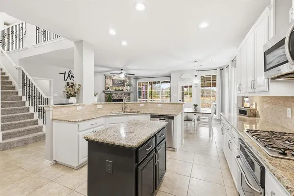 a kitchen with a stove a sink and a refrigerator