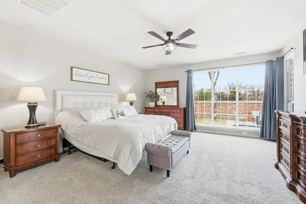 a bedroom with a bed and a large window
