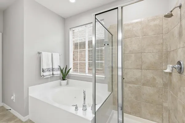 a bathroom with a bathtub and shower