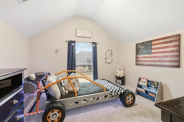 a bedroom with furniture and a tv