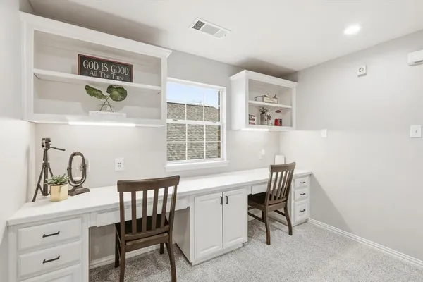 a view of a room that has a table and chairs in it