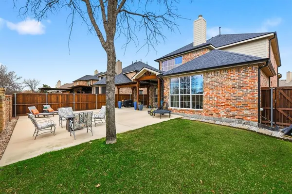 a view of a patio with table and chairs with wooden floor and fence